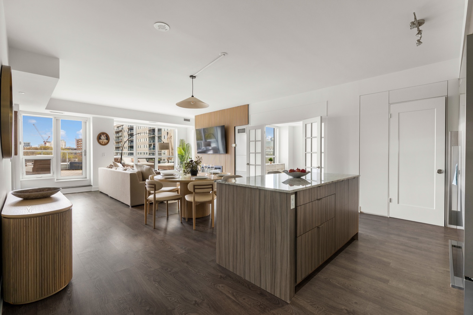 Open-concept living, dining and kitchen area with city views